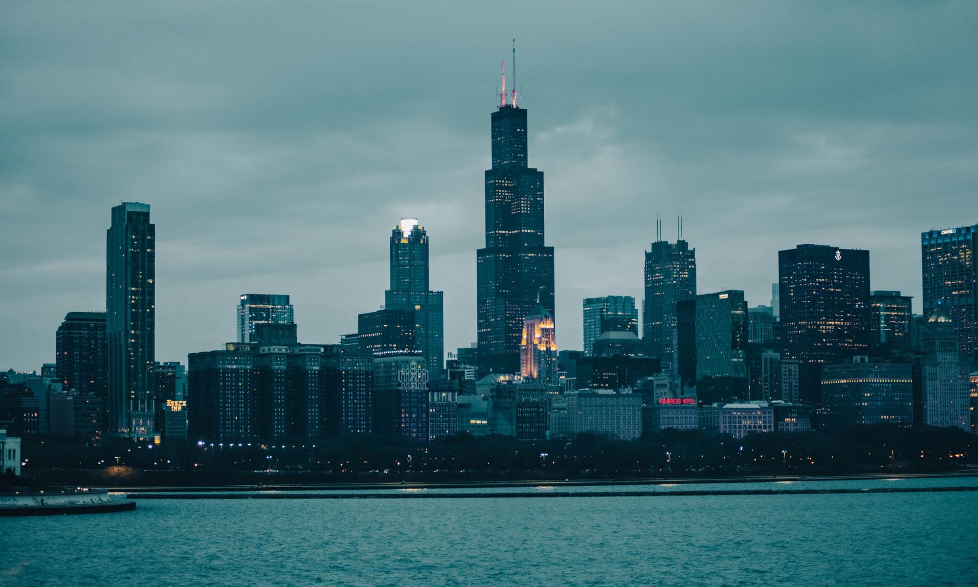 Willis Tower and the Chicago skyline at dusk across Lake Michigan